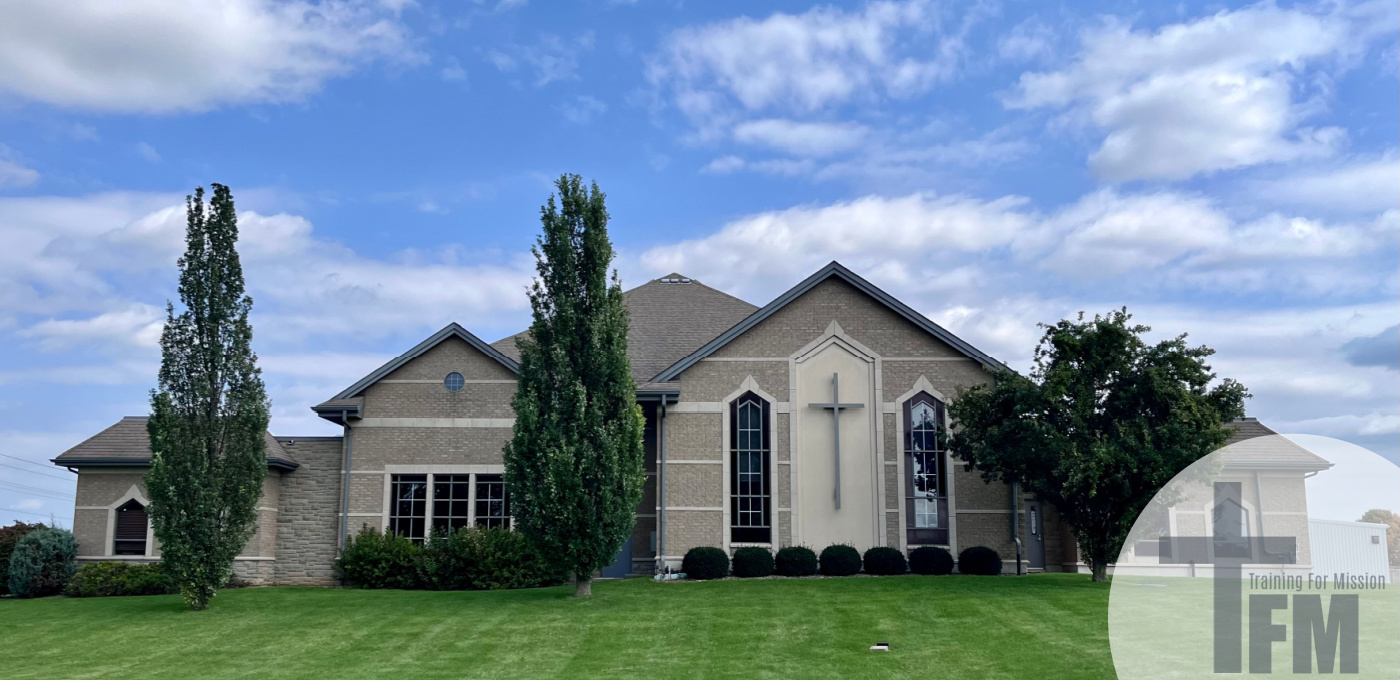 EBC church building with clouds and grass in background
