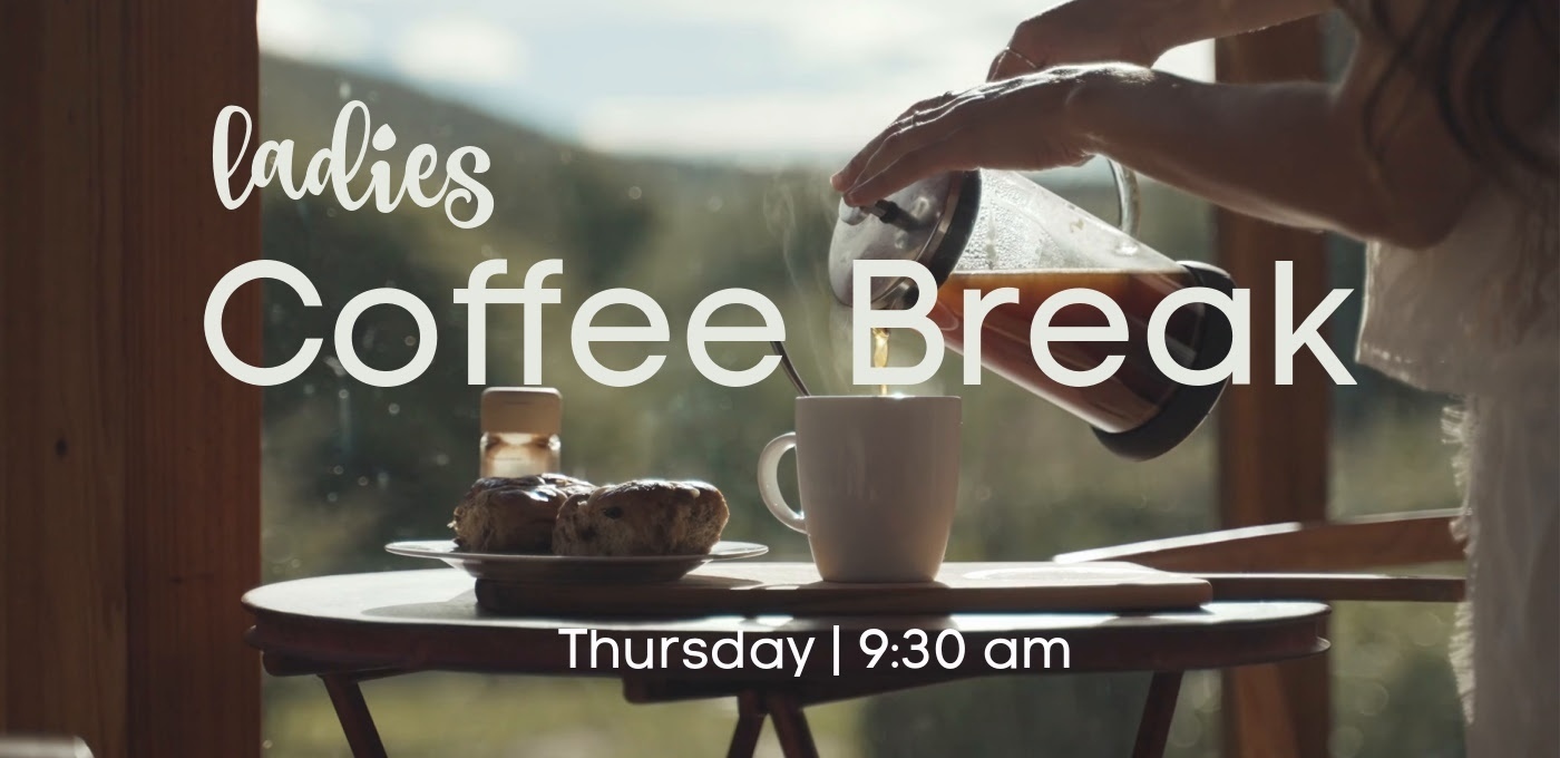 hands pouring coffee into mug beige lettering