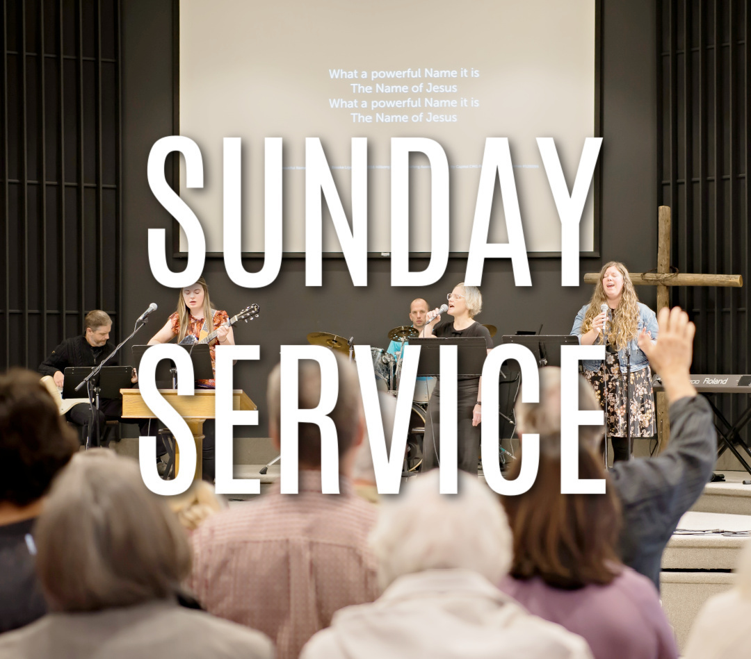 group of people worshipping singing white lettering