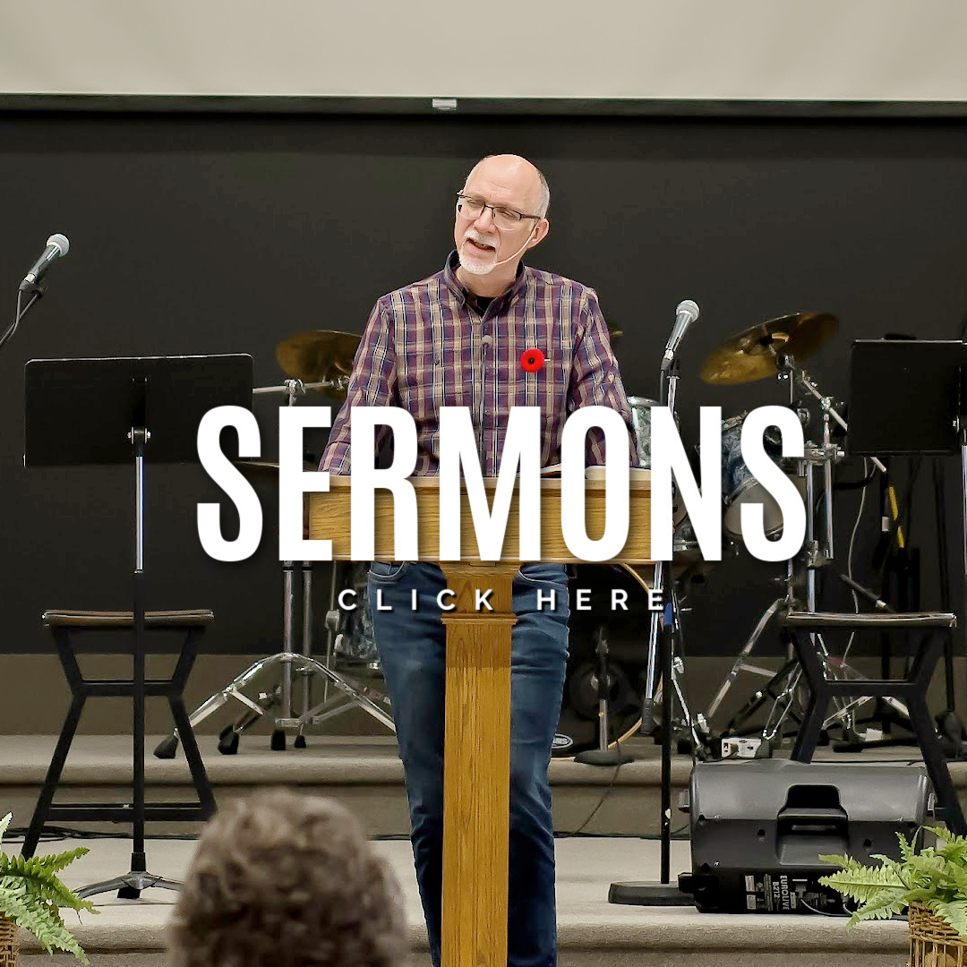man speaking to a crowd plaid shirt white lettering