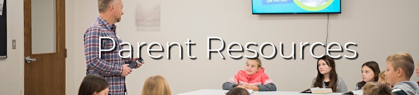 man and students in a classroom with white lettering