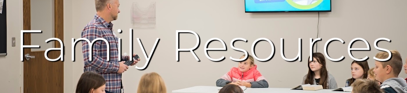 man and students in a clasroom, white lettering