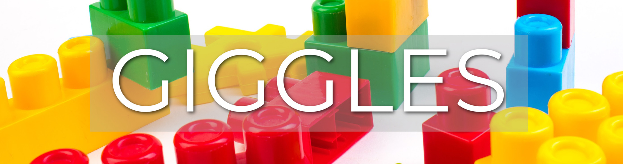 Giggles playgroup on background of large multi coloured lego